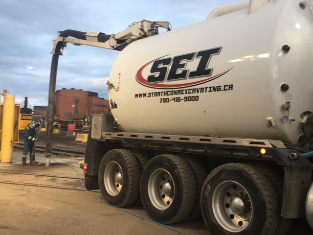 Vac Truck assisting with an underground utility installation